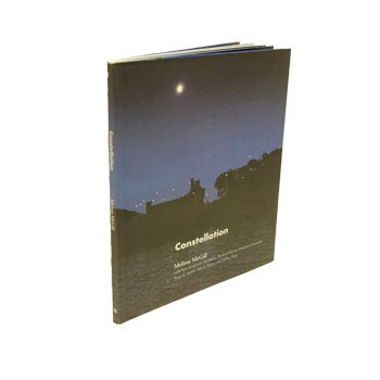 Book cover with photo of Bannerman Castle at night. 