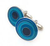 Round cufflinks with blue circular pattern.