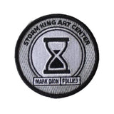 3" iron press patch with hourglass design.