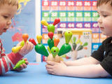 Two pre-school age children playing with cactus toy.